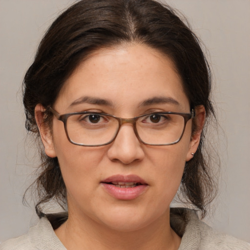 Joyful white adult female with medium  brown hair and brown eyes