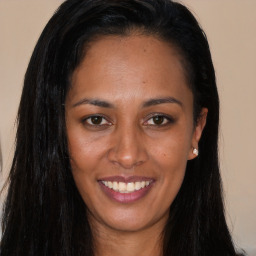 Joyful asian young-adult female with long  brown hair and brown eyes