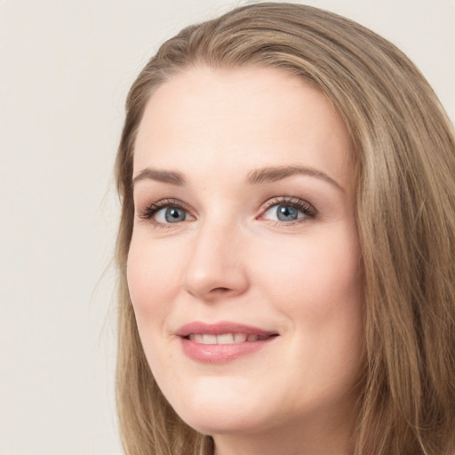 Joyful white young-adult female with long  brown hair and green eyes