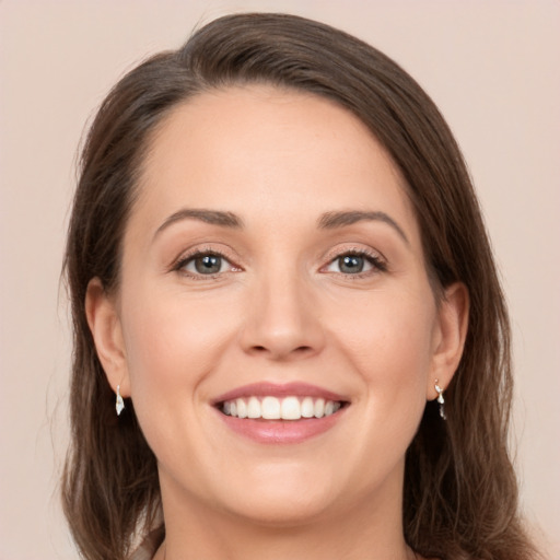 Joyful white young-adult female with long  brown hair and brown eyes