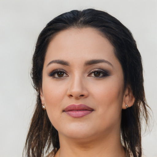 Joyful latino young-adult female with long  brown hair and brown eyes