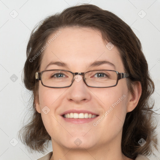 Joyful white adult female with medium  brown hair and blue eyes