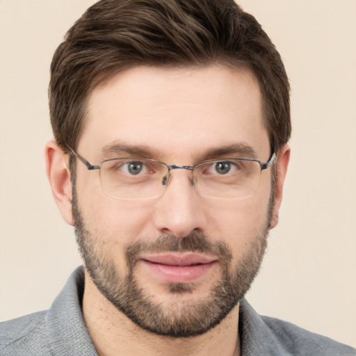 Joyful white adult male with short  brown hair and grey eyes