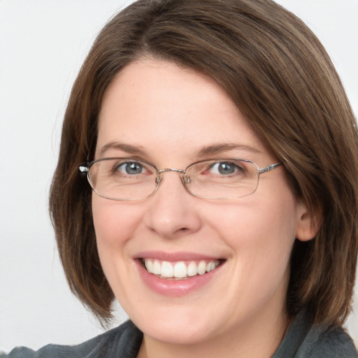 Joyful white adult female with medium  brown hair and grey eyes