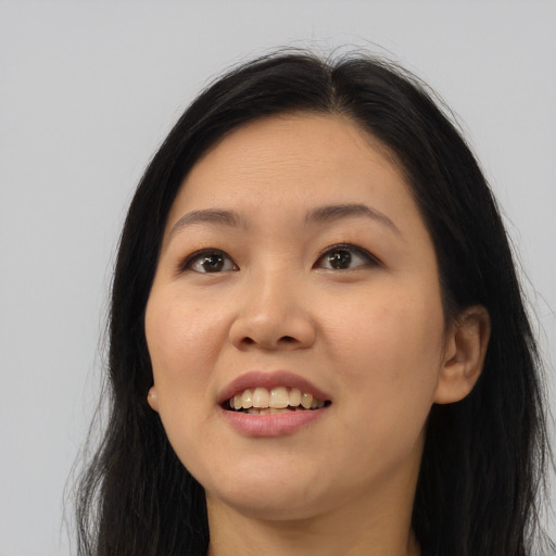Joyful asian young-adult female with long  black hair and brown eyes
