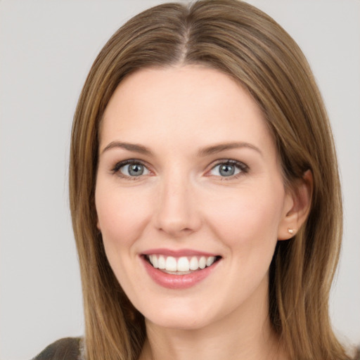 Joyful white young-adult female with medium  brown hair and green eyes