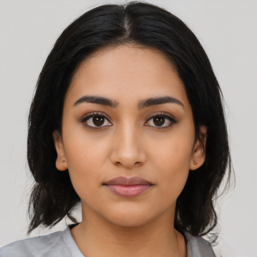 Neutral latino young-adult female with medium  black hair and brown eyes