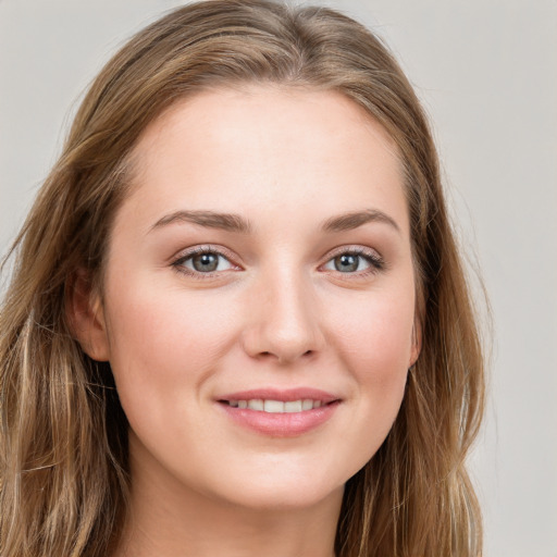 Joyful white young-adult female with long  brown hair and grey eyes