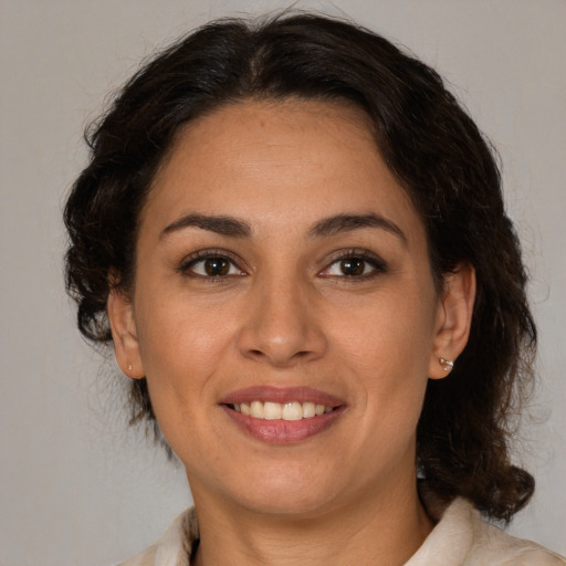 Joyful white adult female with medium  brown hair and brown eyes