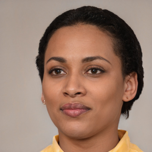 Joyful latino young-adult female with short  black hair and brown eyes