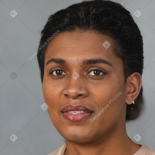 Joyful black young-adult female with short  black hair and brown eyes