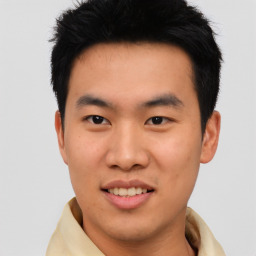 Joyful asian young-adult male with short  black hair and brown eyes