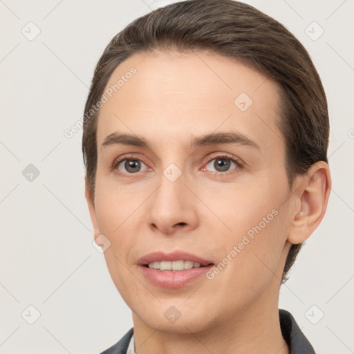 Joyful white young-adult female with short  brown hair and brown eyes