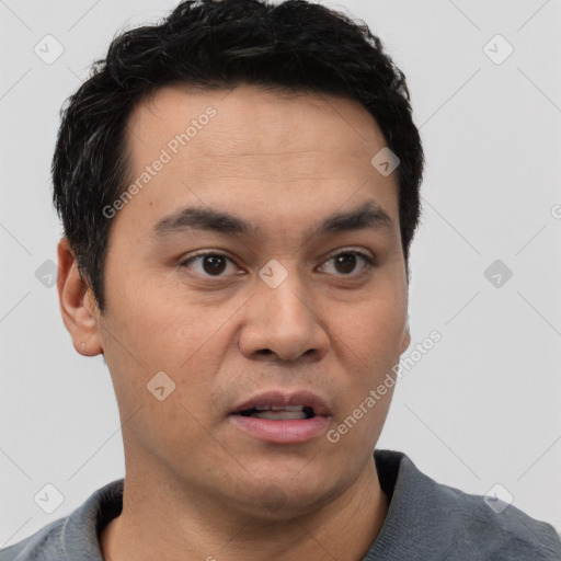 Joyful white young-adult male with short  black hair and brown eyes