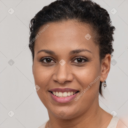 Joyful black young-adult female with short  brown hair and brown eyes