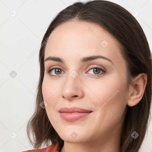 Joyful white young-adult female with long  brown hair and grey eyes