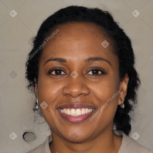 Joyful black adult female with medium  brown hair and brown eyes