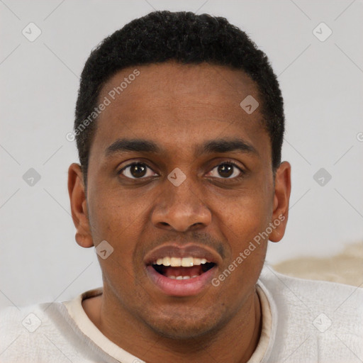 Joyful black young-adult male with short  brown hair and brown eyes