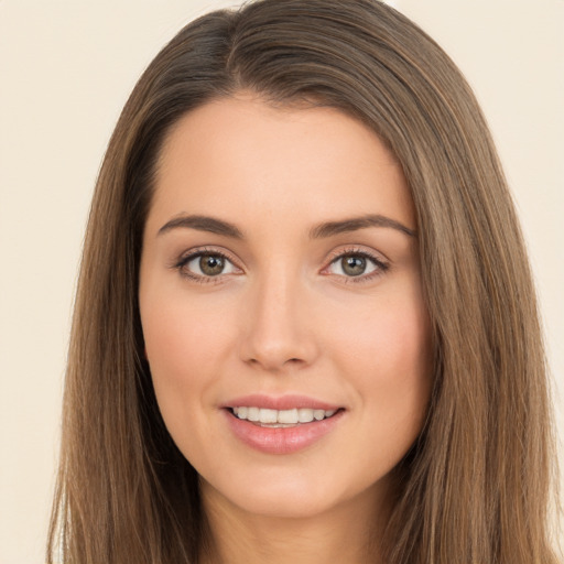 Joyful white young-adult female with long  brown hair and brown eyes