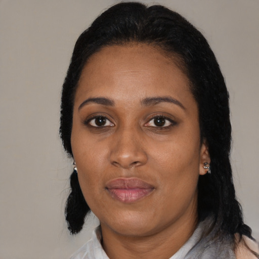 Joyful black adult female with medium  black hair and brown eyes