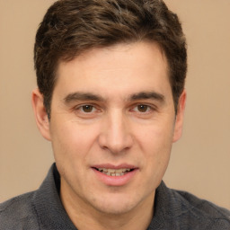 Joyful white adult male with short  brown hair and brown eyes