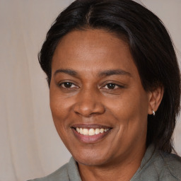 Joyful black adult female with medium  brown hair and brown eyes