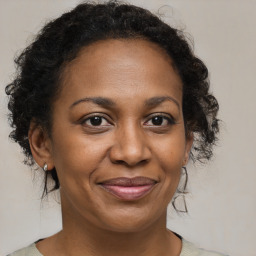 Joyful black adult female with medium  brown hair and brown eyes