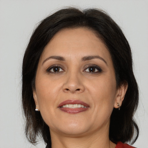 Joyful white adult female with medium  brown hair and brown eyes