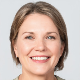 Joyful white adult female with medium  brown hair and grey eyes