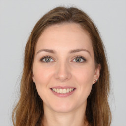 Joyful white young-adult female with long  brown hair and green eyes