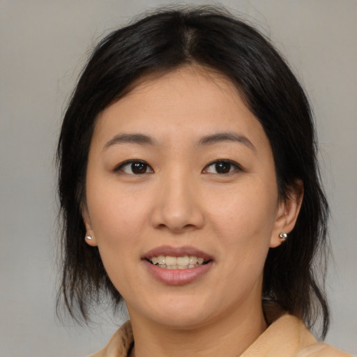 Joyful asian young-adult female with medium  brown hair and brown eyes