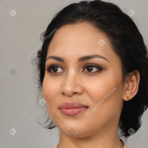 Joyful latino young-adult female with medium  brown hair and brown eyes