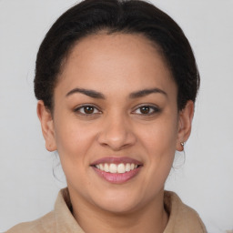 Joyful latino young-adult female with medium  brown hair and brown eyes