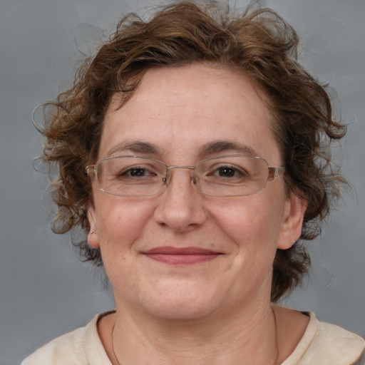 Joyful white adult female with medium  brown hair and blue eyes