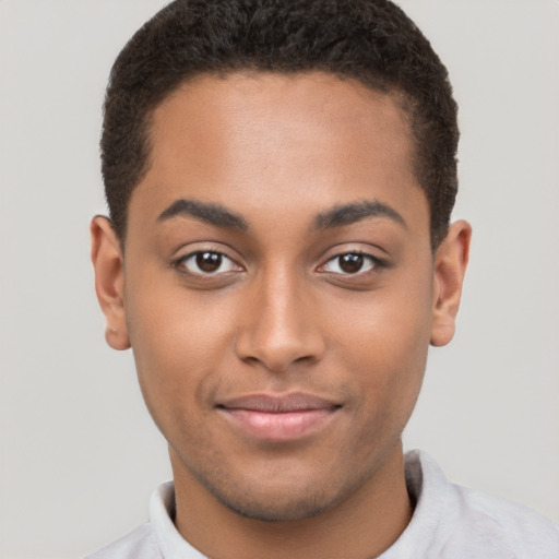 Joyful latino young-adult male with short  brown hair and brown eyes