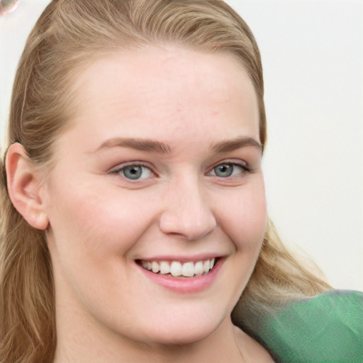 Joyful white young-adult female with long  brown hair and blue eyes