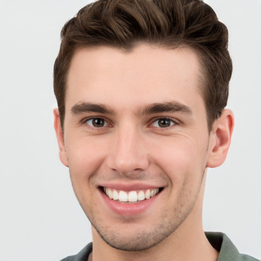 Joyful white young-adult male with short  brown hair and grey eyes