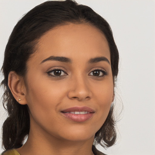 Joyful latino young-adult female with long  brown hair and brown eyes