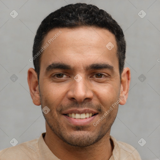 Joyful latino young-adult male with short  black hair and brown eyes