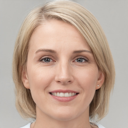 Joyful white young-adult female with medium  brown hair and blue eyes