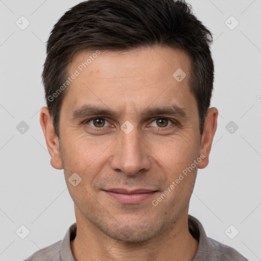 Joyful white adult male with short  brown hair and brown eyes