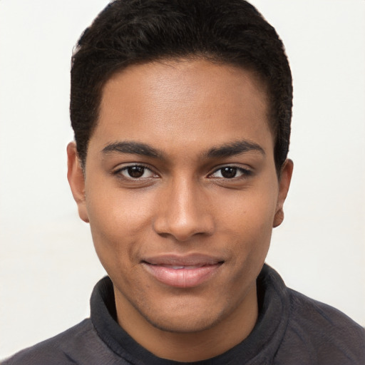 Joyful black young-adult male with short  brown hair and brown eyes