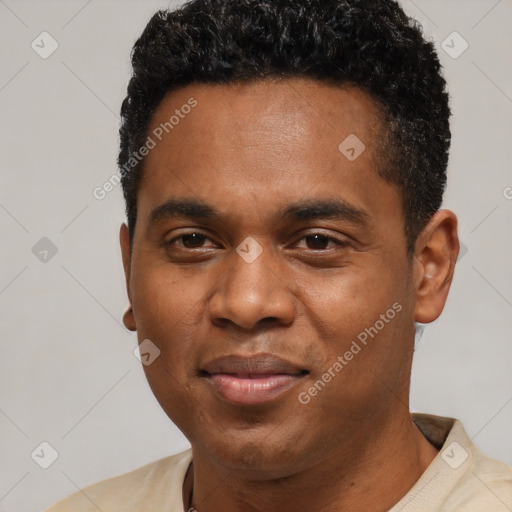 Joyful black young-adult male with short  black hair and brown eyes