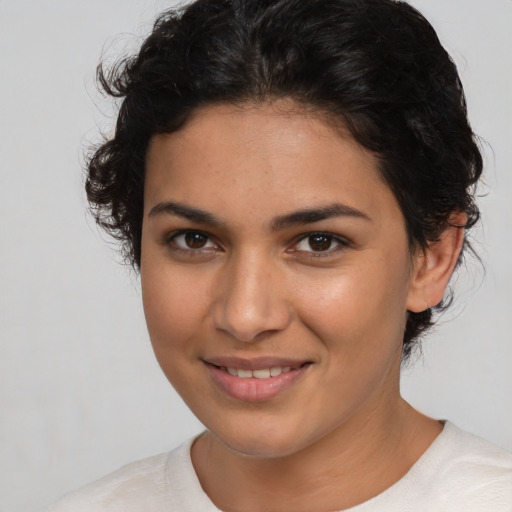 Joyful latino young-adult female with short  brown hair and brown eyes