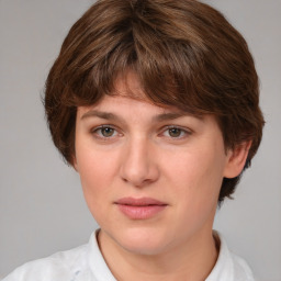 Joyful white young-adult female with medium  brown hair and green eyes