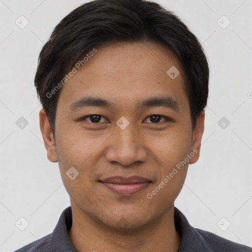 Joyful asian young-adult male with short  brown hair and brown eyes