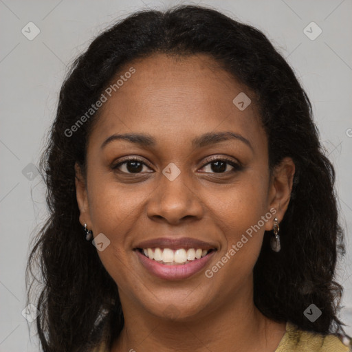 Joyful black young-adult female with long  brown hair and brown eyes