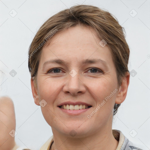 Joyful white young-adult female with short  brown hair and grey eyes