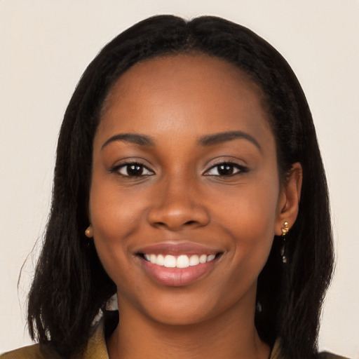 Joyful black young-adult female with long  brown hair and brown eyes