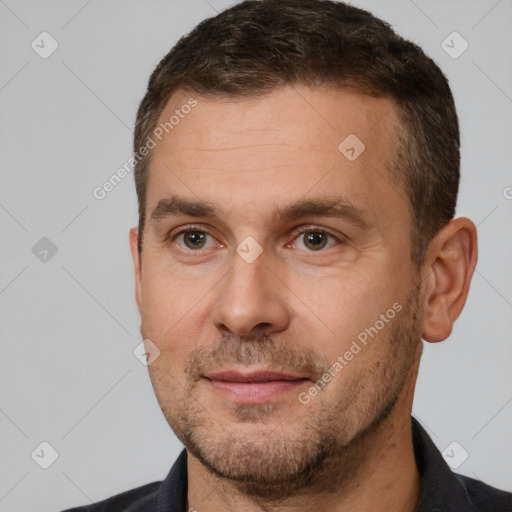 Joyful white adult male with short  brown hair and brown eyes